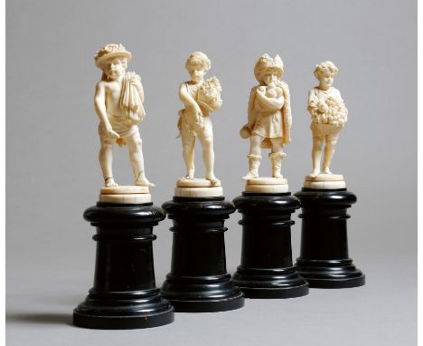 λ A set of four 19th century French Dieppe carved ivory figures, emblematic of the four seasons, modelled as a cherub, winter