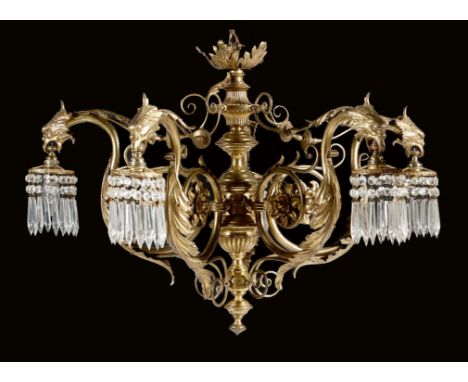 A gilt brass five-light chandelier, with a leaf corona, above a turned fluted and ribbed stem, issuing leaf , flower and scro