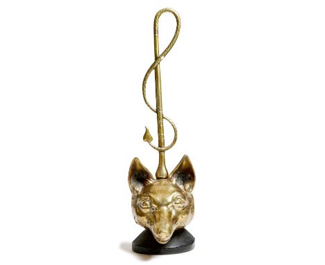 Hunting interest. A brass fox's head doorstop, the handle in the form of a riding crop, the weighted base stamped 'PEERAGE EN