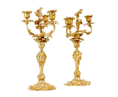 A pair of Louis Philippe ormolu three-light candelabra in Louis XV style, each decorated with scrolls, flowers, leaves and ro