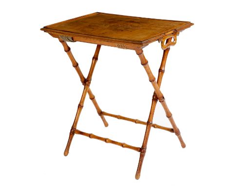 A late Victorian olivewood butler's tray, with a quarter veneered top and a pair of swing handles, on a faux bamboo folding b