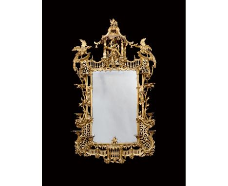 An important George II giltwood and carton pierre wall mirror in the manner of Matthias Lock and John Linnell, the shaped pla