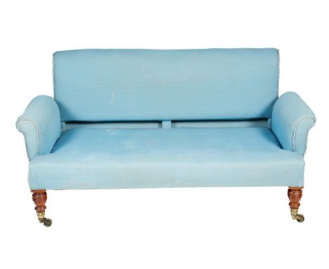 A late Victorian two seater sofa by Howard & Sons, with a scroll back and arms, on turned walnut front legs, the back left le