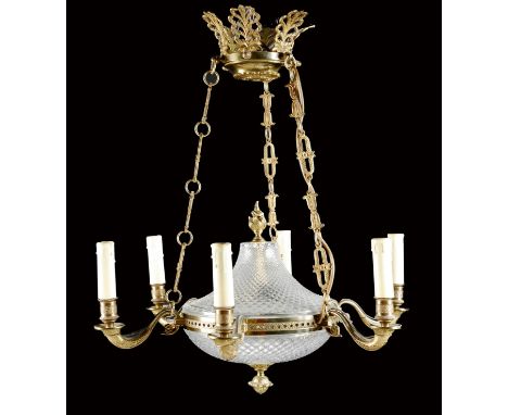 A French Empire style gilt brass and glass six-light chandelier, with an anthemion corona, a flaming urn finial and a bud pen