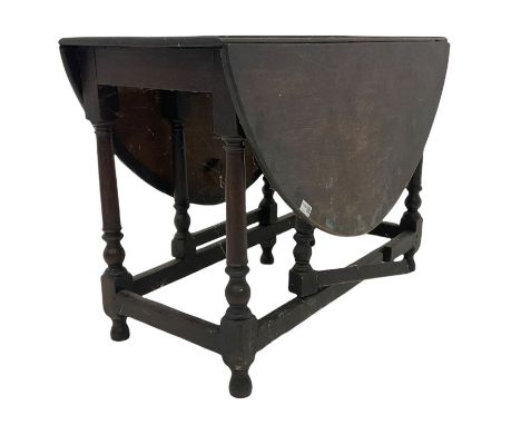 18th century oak gate leg table, the oval top with two drop leaves raised on turned and block supports united by stretcher W9