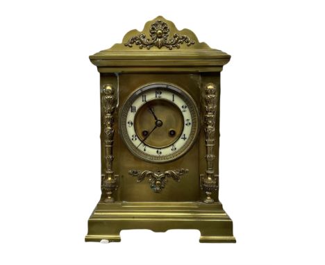 A late 19th century French mantle clock in a brass break-front case with a shaped pediment and cornice, applied cast brass or