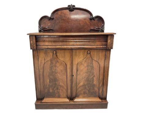 Victorian mahogany chiffonier, the raised back with applied scroll carved decoration, over cushion fronted frieze drawer and 