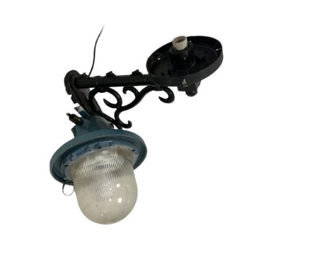 20th century cast metal street light, scroll work bracket, (No bulb or cover) together with a mid 20th century industrial cas