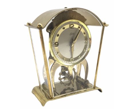 A vintage Schatz &amp; Sohne German eight-day mantle clock with visible oscillating balance, integral key, white dial with gi