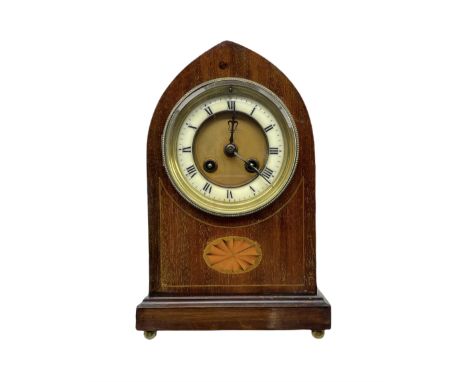 An Edwardian mahogany veneered Lancet cased mantle clock with oval inlay and stringing, on a moulded plinth raised on four bu