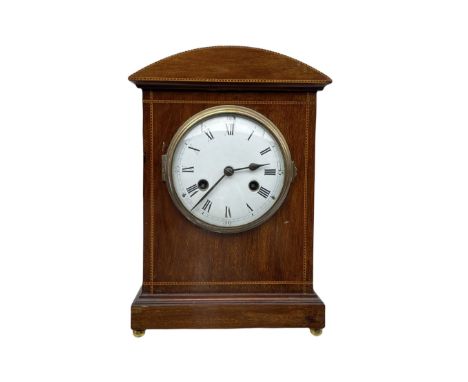An early 20th century German mantle clock by Philipp Haas &amp; Söhne, in a mahogany case with a curved top and inlay, white 