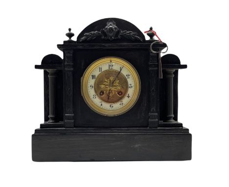 A  late 19th century French mantle clock in a Belgium slate case with an arched top and stepped plinth, with recessed pillars