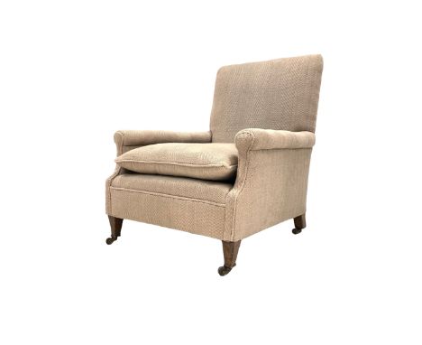 Edwardian oak framed armchair upholstered in a herringbone brown fabric, raised on square tapered supports terminating in bra