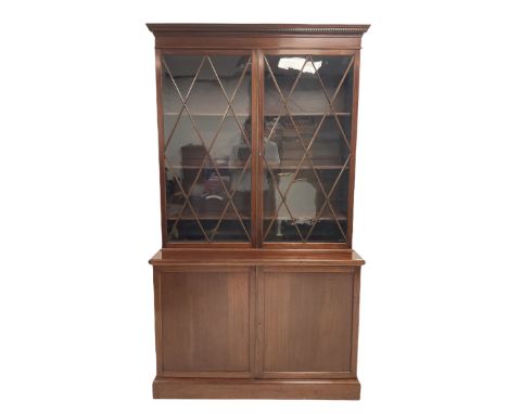 Georgian style mahogany display cabinet, the projecting dental cornice over two glazed doors of astragal design opening to re