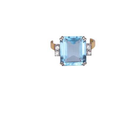 British Circa 1970 An aquamarine, diamond and 18 carat gold dress ring Set to the centre with a step cut rectangular shaped a