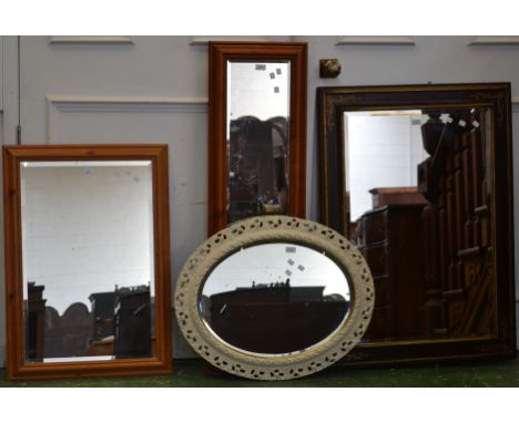 A decorative oval mirror; three rectangular mirrors
