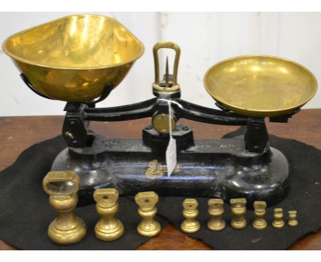 A set of cast iron scales, with brass pans, Libra Scale Co.; a set of 9 brass weights