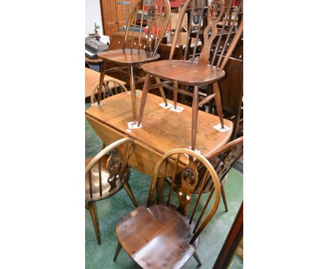 An Ercol dropleaf table; six Windsor spindleback chairs (7)