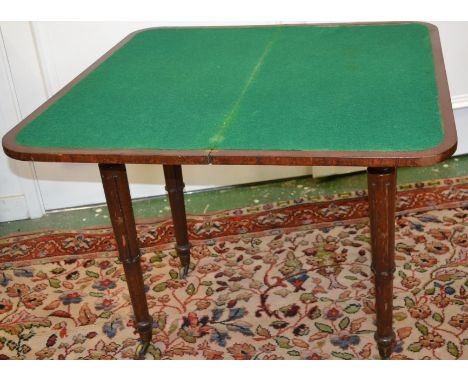 A Regency mahogany card table, fold over top, opening to green baize playing surface, tapering legs, brass casters