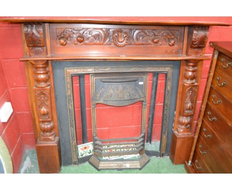 A reproduction cast metal tile surround fireplace, teak mantel 