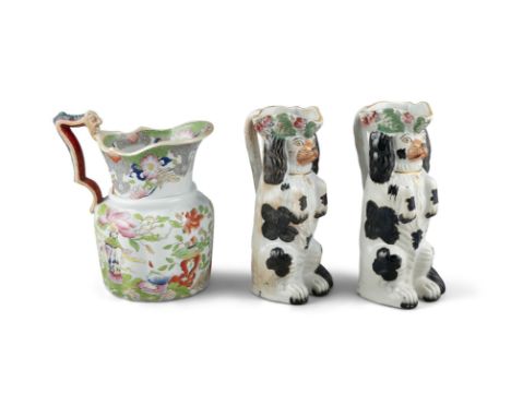 A PAIR OF 19TH CENTURY STAFFORDSHIRE JUGS, moulded in the form of spaniels. 26cm high; Together with a Mason’s ironstone jug.