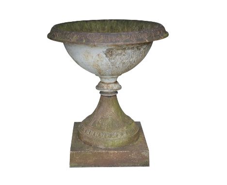 A LARGE VICTORIAN CAST IRON GARDEN URN, with everted circular rim, the body cast with upright leaves and fan motifs, waisted 