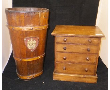 A circa 1900 miniature table top chest of four drawers, a coopered oak bucket, two wooden cased Corpus Christi and a plated C