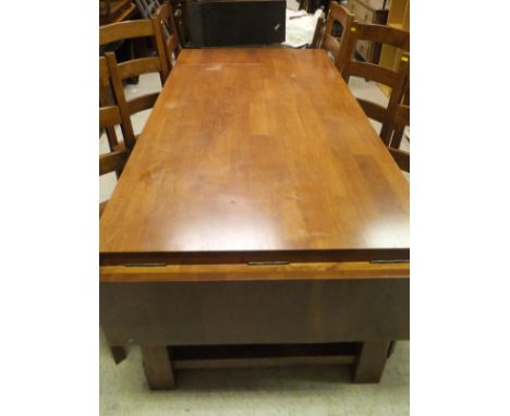 A late 20th Century mahogany drop-leaf rectangular dining table and a set of six ladder back dining chairs