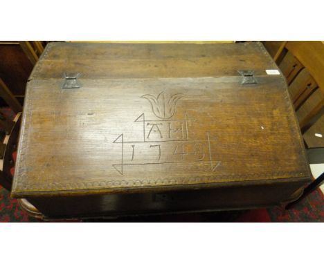 A mid 18th Century oak Bible box, the fall carved "AH 1748" opening to reveal three short drawers over a deep recess, with an