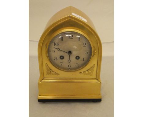 A brass cased mantel clock of lancet form, the movement by Japy Frères of Paris with silvered dial and Arabic numerals