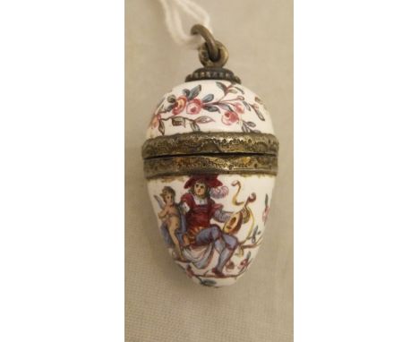 A 19th Century Continental silver gilt and enamel decorated vinaigrette in the form of an egg, the body decorated with floral