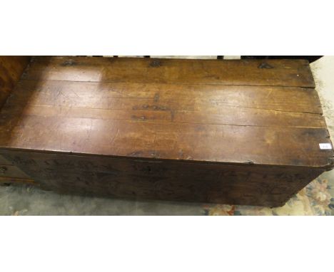 A 17th Century Cyprus chest with planked cypress top, the front panel decorated with low relief carving depicting mythical be