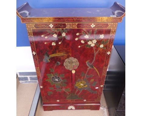 A pair of OKA red lacquered Chinese style cabinets, decorated with birds amongst blossoming branches, the doors opening to re