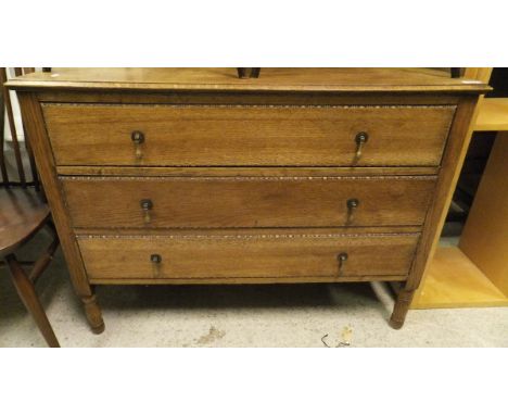 A early 20th Century oak chest of three long drawers raised on turned and ring legs together with a set of four dark elm Erco