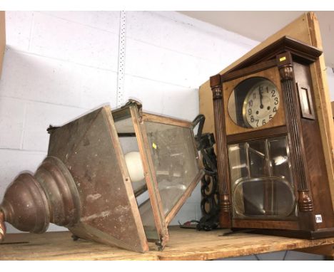 A copper lantern and a mahogany wall clock