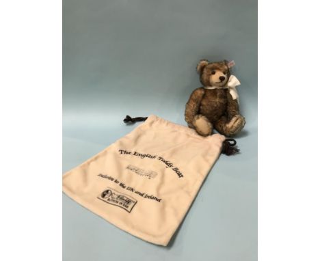 A Steiff 'The English Musical' Teddy Bear, with white tag, number 660979, brown tipped mohair, wearing a cream silk ribbon, p