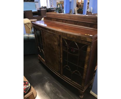 A walnut bow front china cabinet