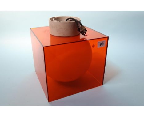 An orange Perspex light fitting