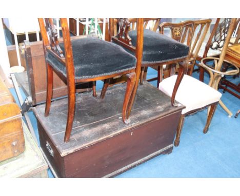 A pine trunk and three various chairs