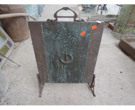 A copper and cast fire screen