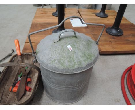 A galvanised lidded bucket , trug with garden tools