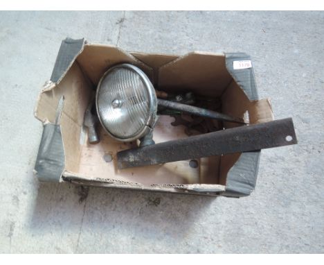 A box containing tools and a vintage tractor light