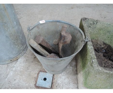 A galvanised bucket and vintah=ge hand tools
