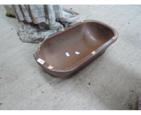 A shallow salt glazes trough