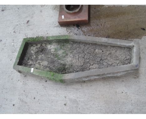 A shallow stone trough of irregular shape 