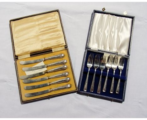 A boxed set of silver-handled tea knives, a boxed set of bone-handled and silver plate fruit knives and forks, a pair of silv