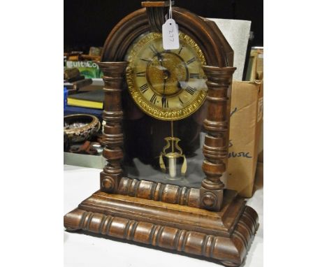 German stained wood mantle timepiece with turned finial over arch with half-turned pilasters flanking glazed door opening to 