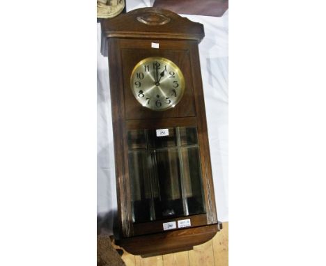 Early 20th century oak cased wall clock with silvered dial and glazed panel door, striking and chiming movement, height 80cms