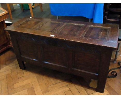 Late 17th century oak coffer having quadruple framed panel top, lunette carved foliate style frieze to the panelled front and