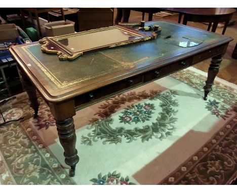 Victorian mahogany writing/library table having ogee mould edge, gilt tooled inset leather panel, fitted three frieze drawers